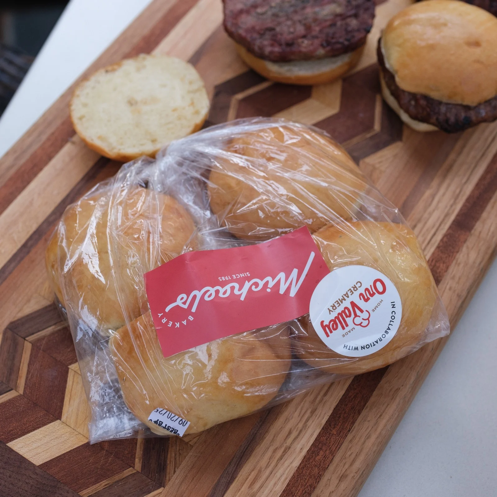 A burger from Orr Valley Creamery served on a Michaels Bakery bun, with the branded bag visible