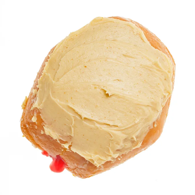 Peanut butter and jelly donut, a bismark filled with strawberry jelly and topped with peanut butter icing, from Michaels Bakery